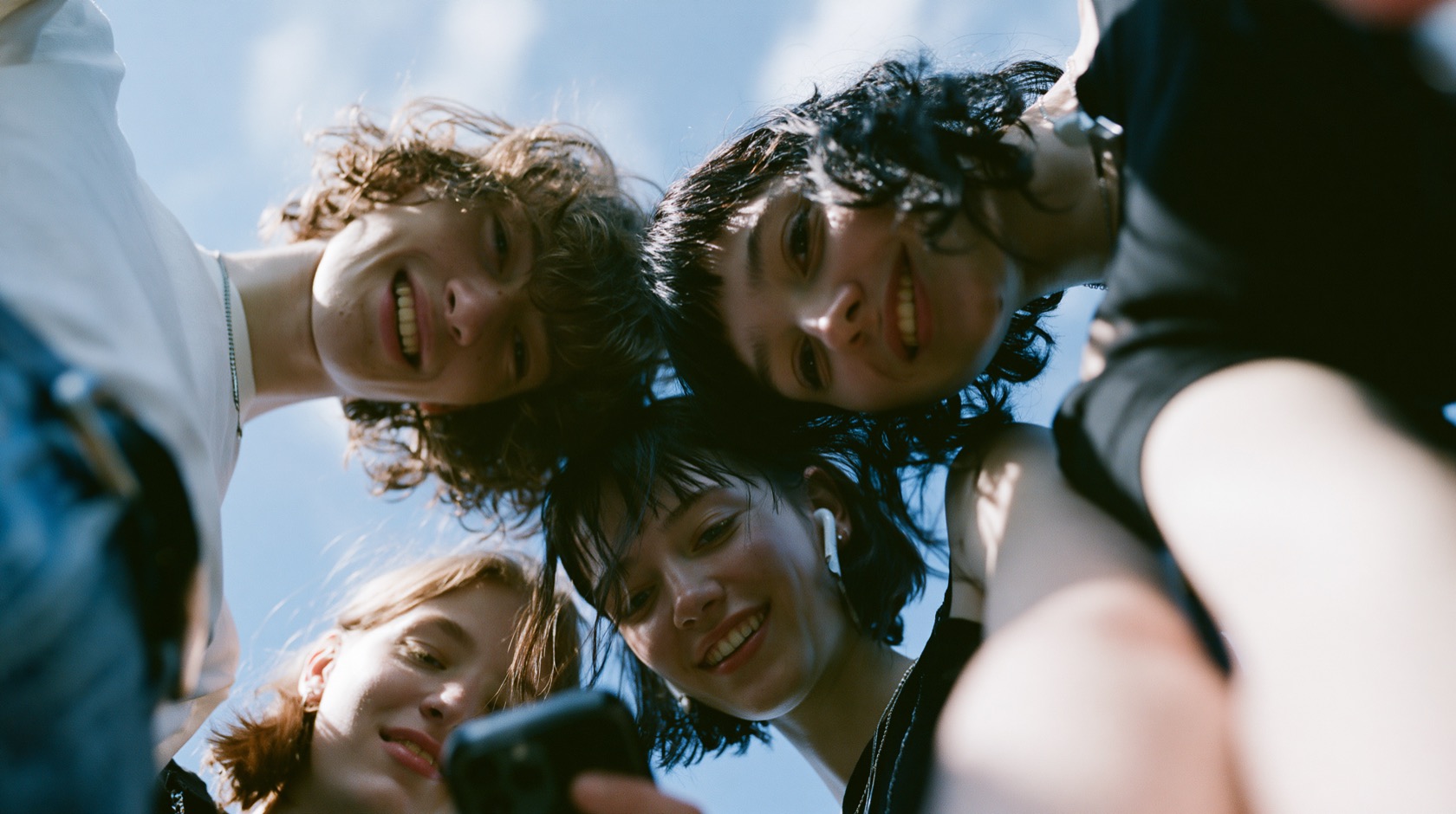 A group of young friends smiling together outdoors